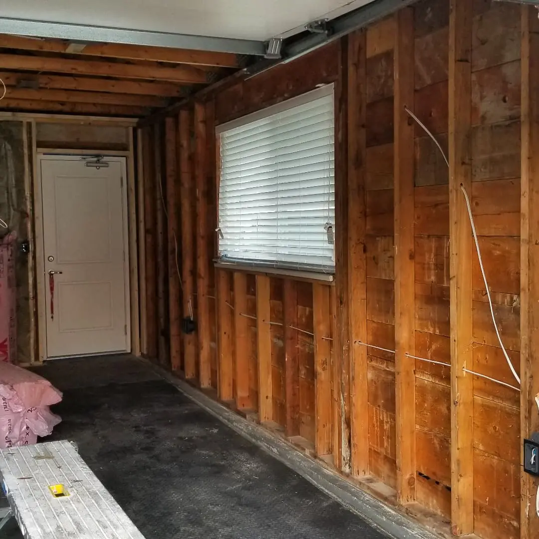 A room with wood paneling and a door.