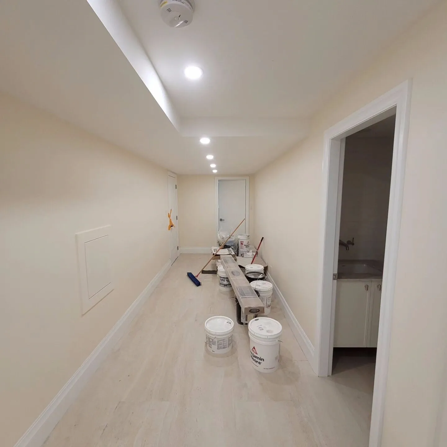 A hallway with white walls and floors.