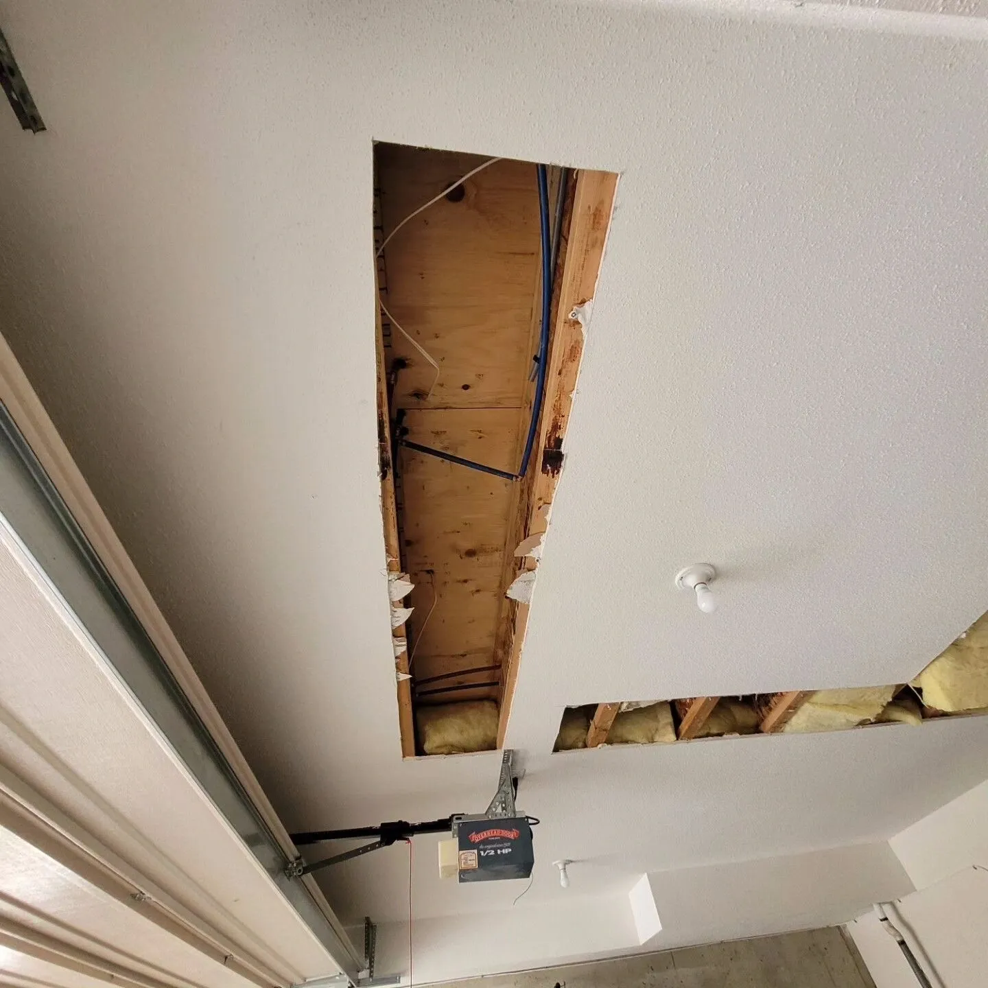 A ceiling that has been torn off and missing the support bars.