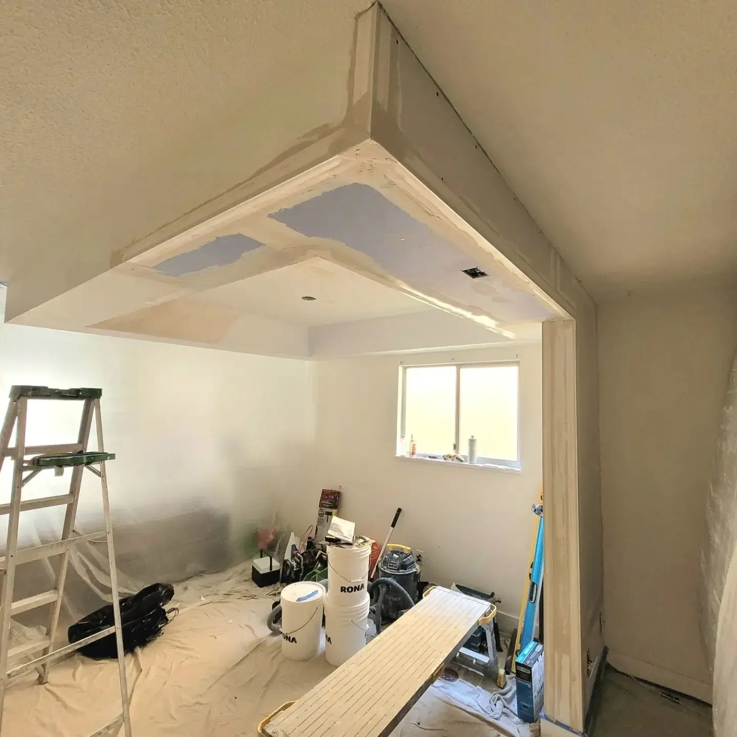 A room being remodeled with the ceiling up.