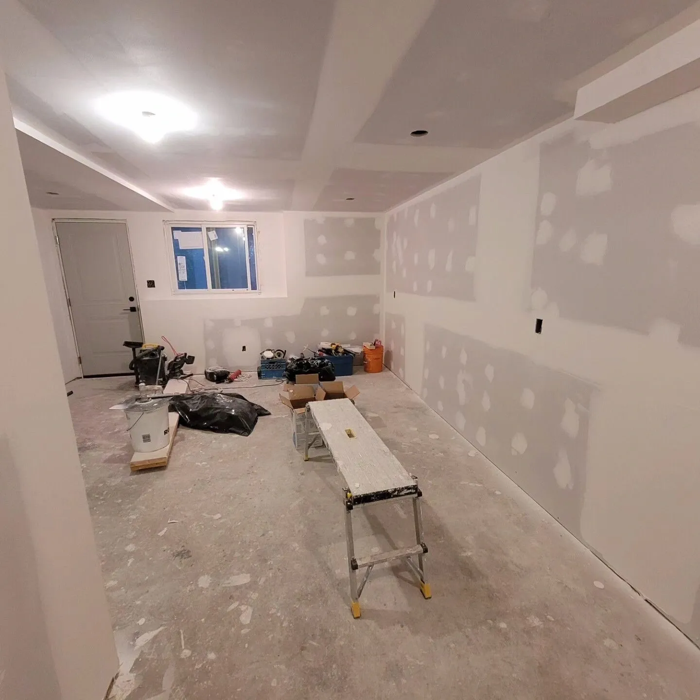 A room with walls and floors being remodeled.