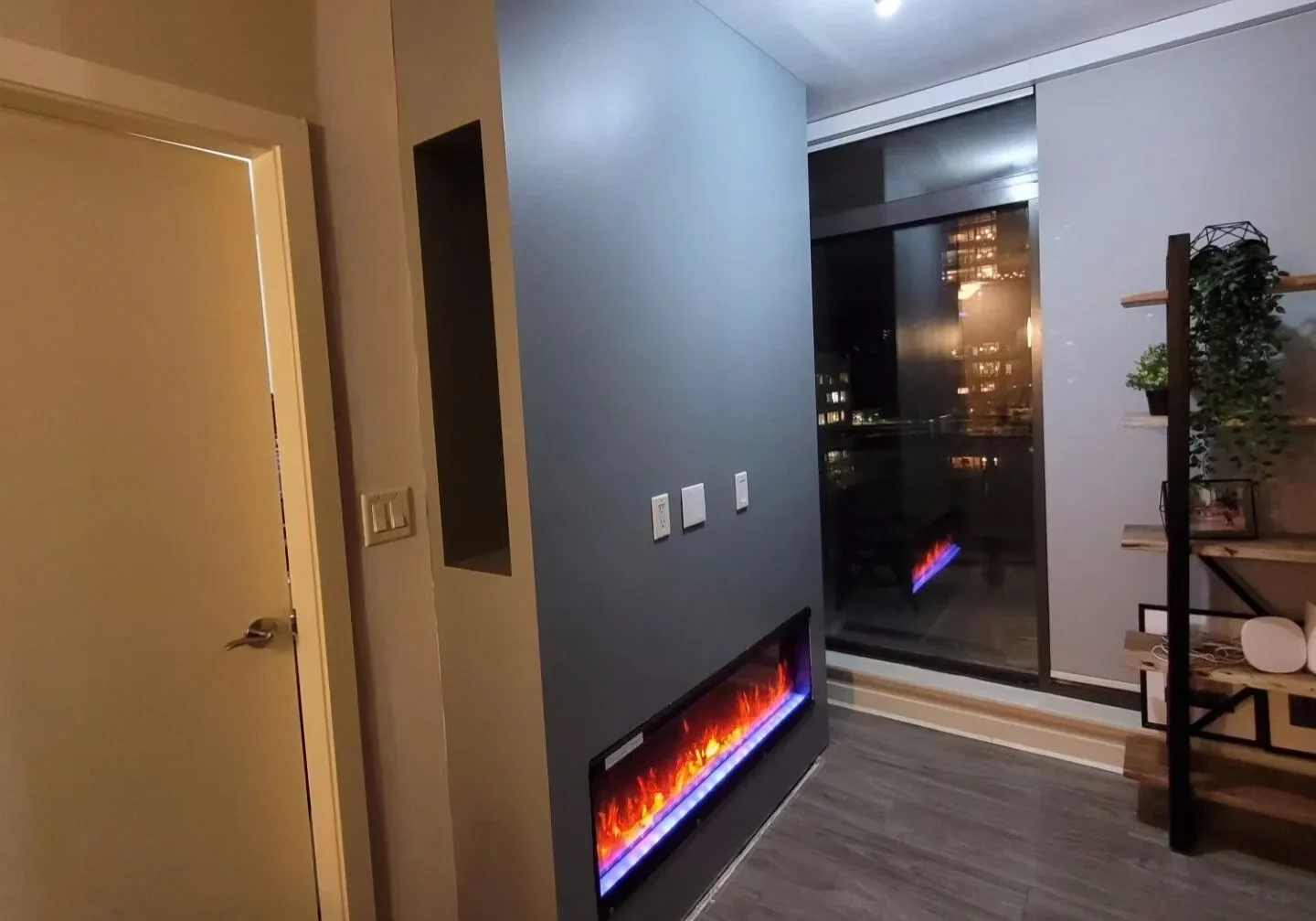 A room with a fireplace and a door.